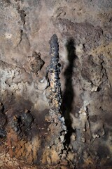 Old lava tube on Galapagos Islands with stalactite and stalagmite