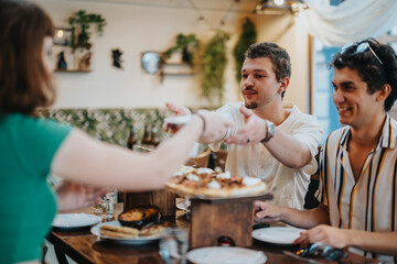 A group of friends sharing food and laughter at a cozy restaurant, creating a warm and joyful atmosphere with smiles and camaraderie.