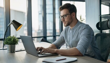 Fototapeta premium young man working on laptop in office
