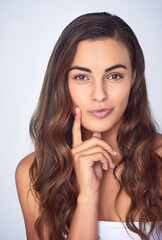 Naklejka premium Portrait, woman and thinking for skincare routine, beauty and pride for confidence or cosmetics. Female person, skin and natural glow on studio background in dermatology, face and wellness with idea