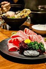 Marbled Beef Slices on Display with Vibrant Garnish. A mouthwatering platter featuring perfectly marbled beef slices arranged on a sleek black plate, accompanied by colorful garnishes.