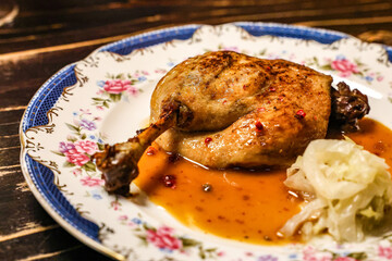 Roasted Duck Leg with Glaze and Pickled Cabbage. A beautifully roasted duck leg served with a flavorful glaze and a side of tangy pickled cabbage.