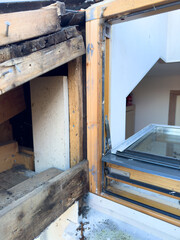 Image of open hole for roof window light, window frame during construction renovation of house