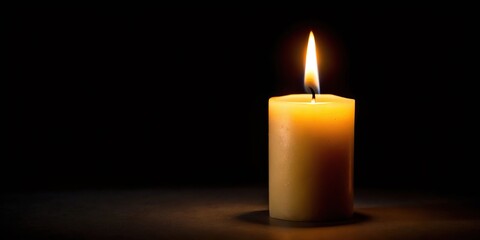 One light candle burning brightly in the black background Extreme Close-Up