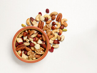Walnut, macadamia nut, cashew nut, pecan on the plate and isolated on white background. Pile of...