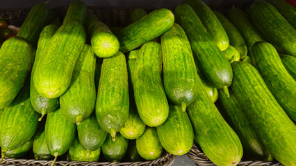 Cucumbers background. Cucumbers on store shelves. Vegetables in the store
