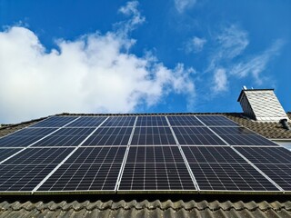Solar panels producing clean energy on a roof of a residential house