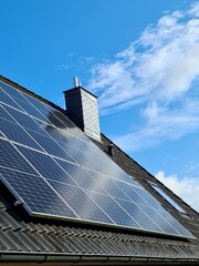 Solar panels producing clean energy on a roof of a residential house