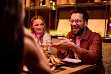 Group of Friends Enjoying a Lively Dinner Conversation