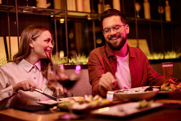 Smiling Couple Enjoying Dinner at Cozy Restaurant Table