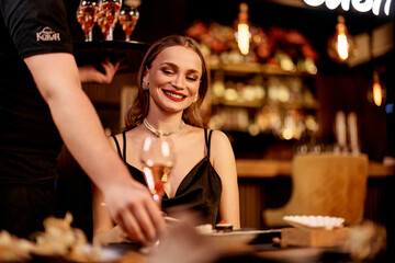 Smiling Woman Enjoying Elegant Night Out at a Luxurious Restaurant