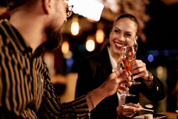 Friends Celebrating With Champagne Toast At Elegant Restaurant