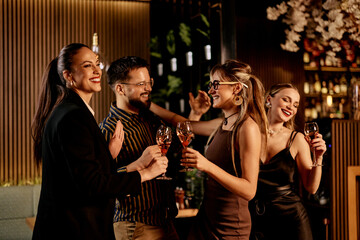 Friends Celebrating with Wine at a Stylish Nightclub Gathering
