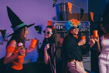 Joyful office Halloween party with coworkers in costumes, celebrating with drinks and laughter, fostering teamwork and festive spirit
