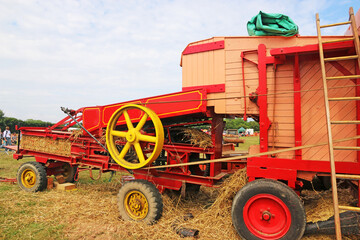 Vintage thresher working in a field