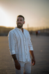 Fototapeta premium Strong young man posing in Menorca at sunset