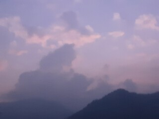 Soft pastel twilight sky with silhouetted mountains, creating a dreamy, introspective atmosphere. Ideal for relaxation or nature-focused themes.