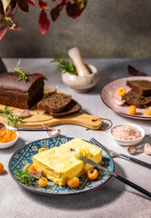 Spreading butter on rustic table with bread and raspberries