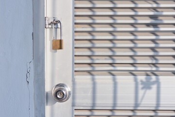 golden lock with locked gray metal door texture background