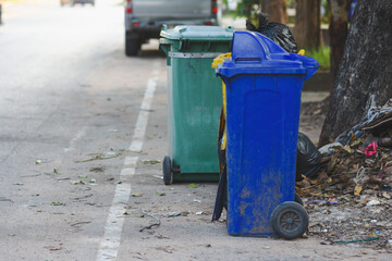 Plastic bins filled with trash and debris in public places