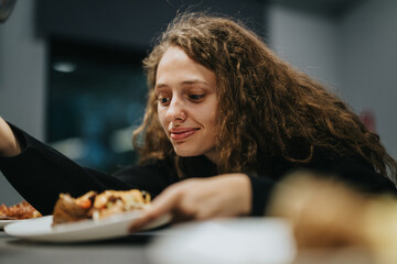 A teenage girl with curly hair smiles as she reaches for a plate of delicious food, creating a warm...