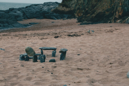 a mini stone henge on the beach, created by kids earlier in the day