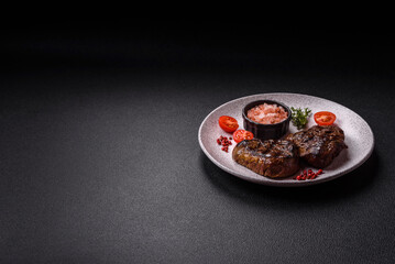 Juicy beef steak baked on the grill with salt, spices and herbs