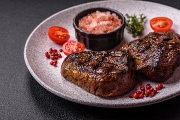 Juicy beef steak baked on the grill with salt, spices and herbs
