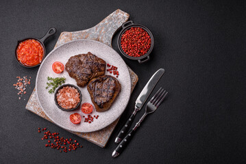 Juicy beef steak baked on the grill with salt, spices and herbs
