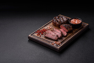 Juicy beef steak baked on the grill with salt, spices and herbs