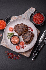 Juicy beef steak baked on the grill with salt, spices and herbs