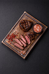 Juicy beef steak baked on the grill with salt, spices and herbs