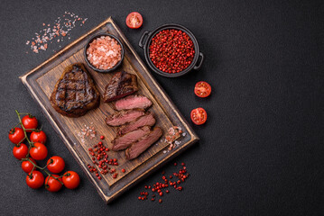 Juicy beef steak baked on the grill with salt, spices and herbs