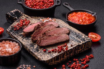 Juicy beef steak baked on the grill with salt, spices and herbs