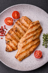 Juicy chicken fillet baked on the grill with salt, spices and herbs