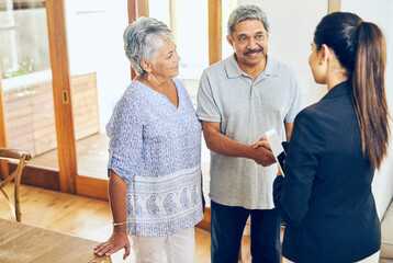 Financial advisor, handshake and senior couple in home with smile, welcome and introduction for...