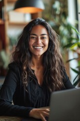 A person sitting in front of a laptop, focused on her work