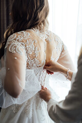 Fototapeta premium Bride and bridesmaids during the wedding preparations