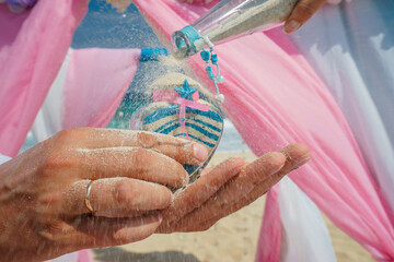 Decorations for wedding in the beach, Accessory kit bottles with sand for a wedding is on the table on the coastline of caribbean sea	
