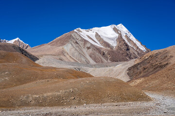 Colorful landscape view of high-altitude snow-capped Karakoram range mountains in Khunjerab National Park, Hunza, Gilgit-Baltistan, Pakistan