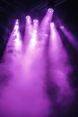 Dramatic purple lighting fills a stage with mist during a theatrical performance at night