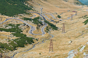 Transfăgărășan Highway, Romania - September 6, 2024: A breathtaking aerial view of the Transfagarasan Highway in Romania, showcasing its winding curves, scenic mountains, and dramatic landscapes.
