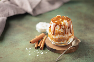 Homemade Spanish Arroz con Leche or South American Dulce de Leche Rice Pudding in glass on the table