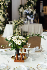 Luxurious restaurant. Luxurious interior, white tables, serving dishes and glasses for guests