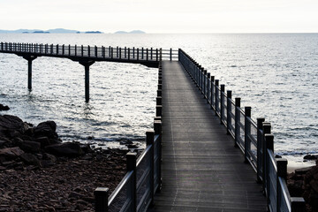 walkway bridge at the seaside during sunset