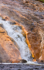 Scenic Waterfall in Yellowstone National Park with Colorful Geological Formations in Wyoming, USA