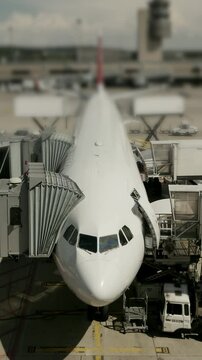 An airplane is situated at the airport terminal, facilitated by comprehensive ground services