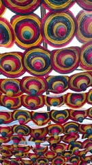 Spanish hats hung between buildings at carnival