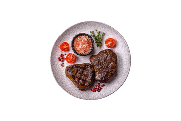 Juicy beef steak baked on the grill with salt, spices and herbs