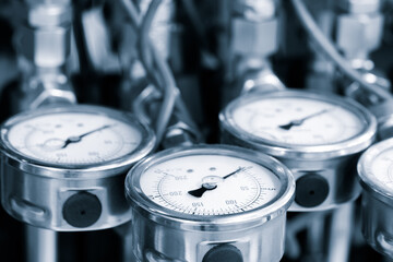 Several pressure gauges in the hydraulic system of a machine, industrial concept background